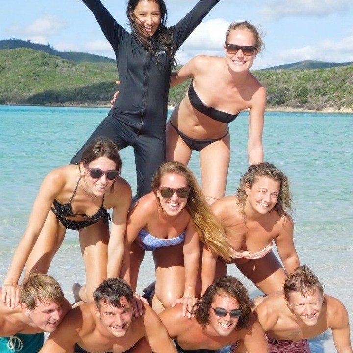 Johnny Whitaker et al. posing in front of a body of water