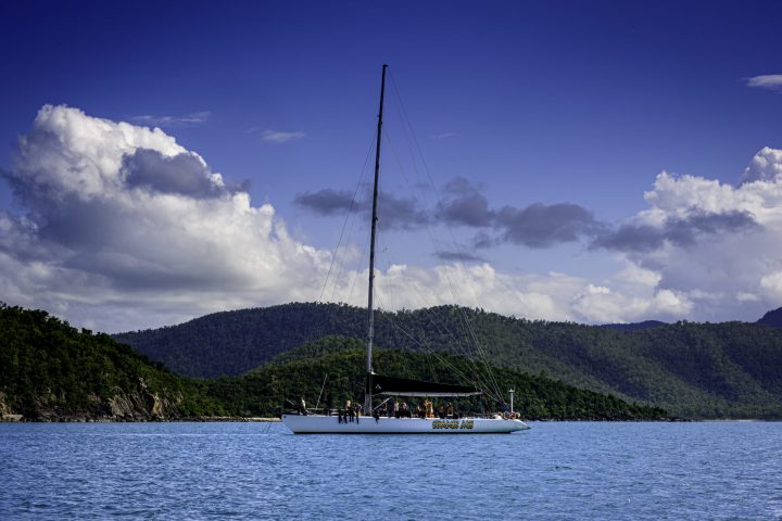 a boat on a body of water with a mountain in the background