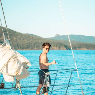 a person standing on a boat in a body of water