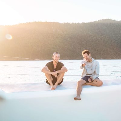a man and a woman sitting at a beach