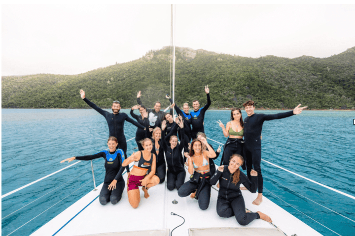 a group of people in a boat on a body of water
