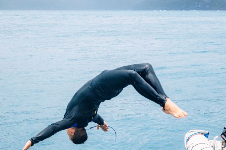 a man riding a wave on top of a body of water