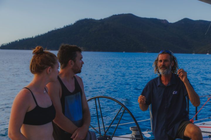 a person standing next to a body of water