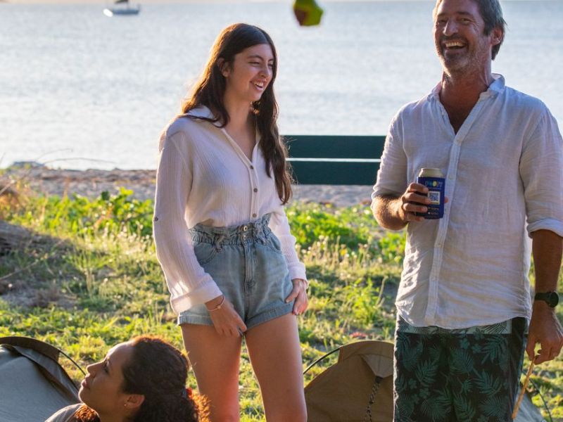 a couple of people that are standing in the grass