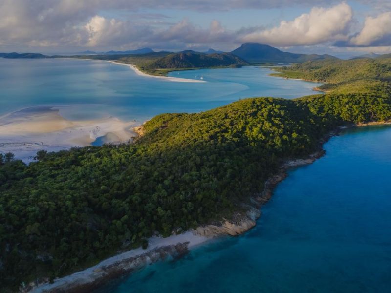 a body of water with a mountain in the background